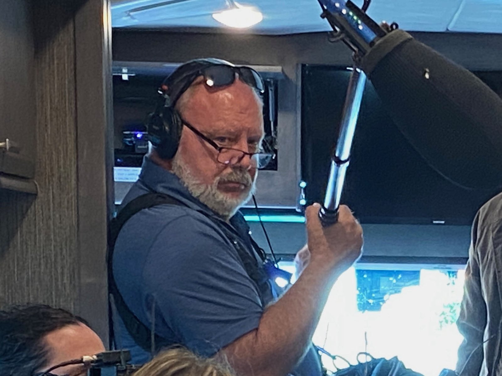 Rusty Duggan booming on set, headphones on